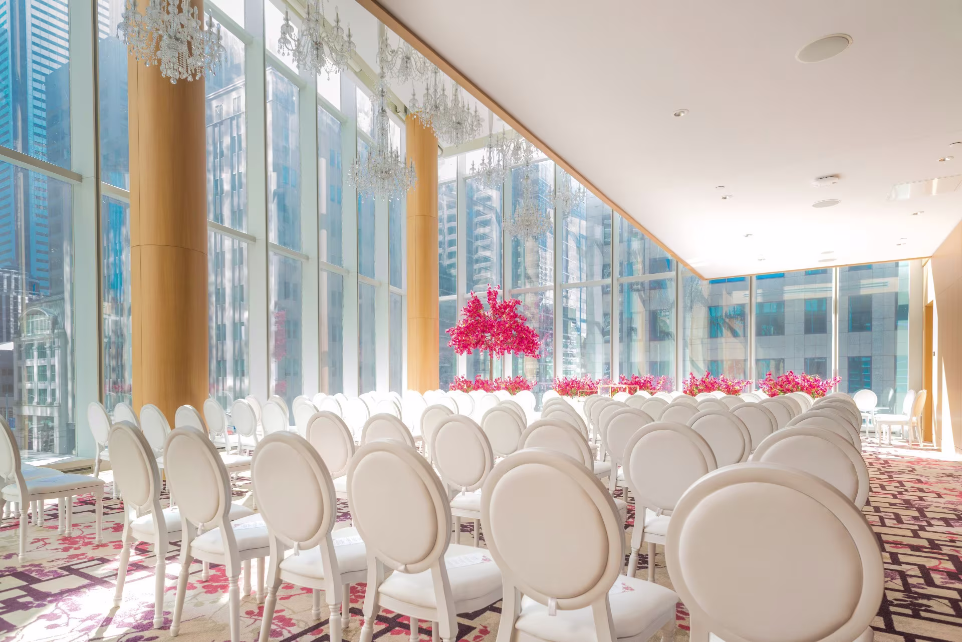 Big Dawg Party Rentals Gallery featuring elegant indoor wedding ceremony seating with white chairs and city views