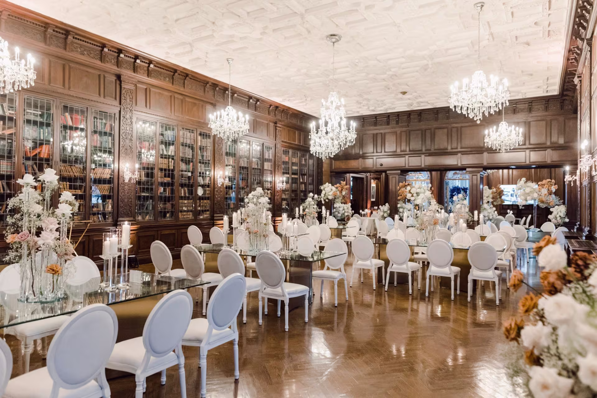 Big Dawg Party Rentals Gallery highlighting a luxury wedding reception with long tables, white chairs, and chandeliers